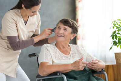 caregiver grooming elderly woman