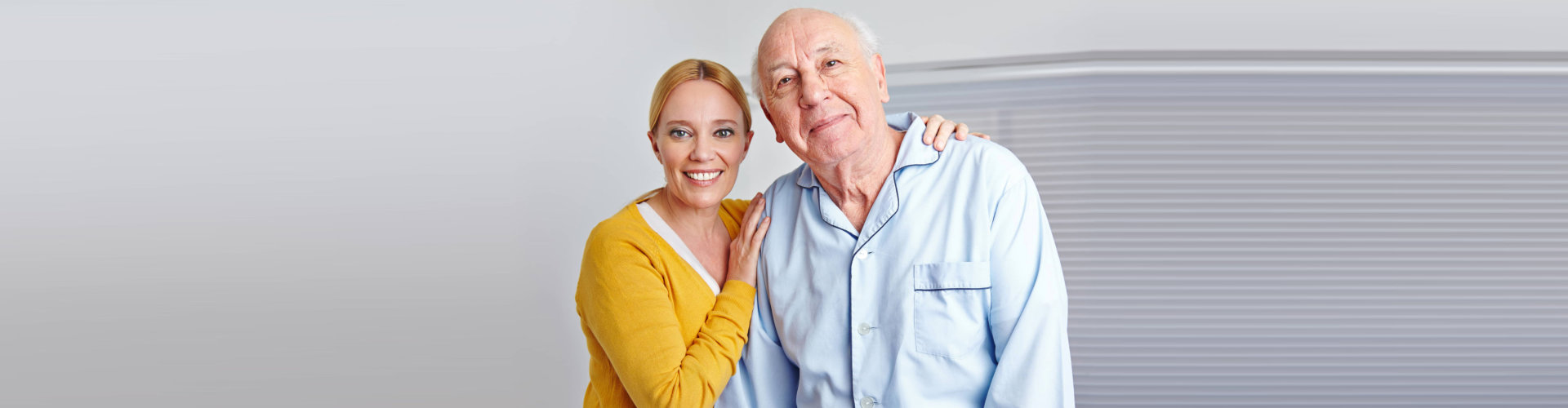 elderly person and caregiver smiling